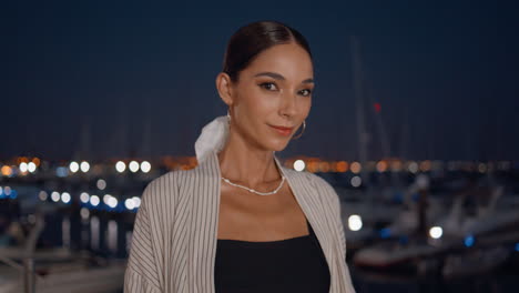 stylish woman at a night marina