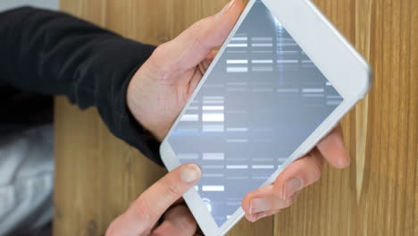 holding tablet, person analyzing dna sequence animation over wooden surface