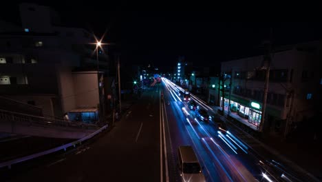 a night timelapse of the traffic jam at the city street in tokyo wide shot