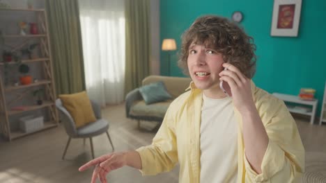 young man talking on phone in living room