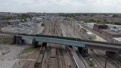 4k aerial footage of a high speed passenger train stopping at peterborough train station