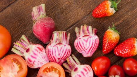 Video-of-fresh-organic-vegan-food-with-strawberries-and-vegetables-on-wooden-board