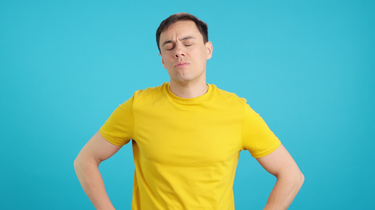 Man in yellow t-shirt with a displeased look