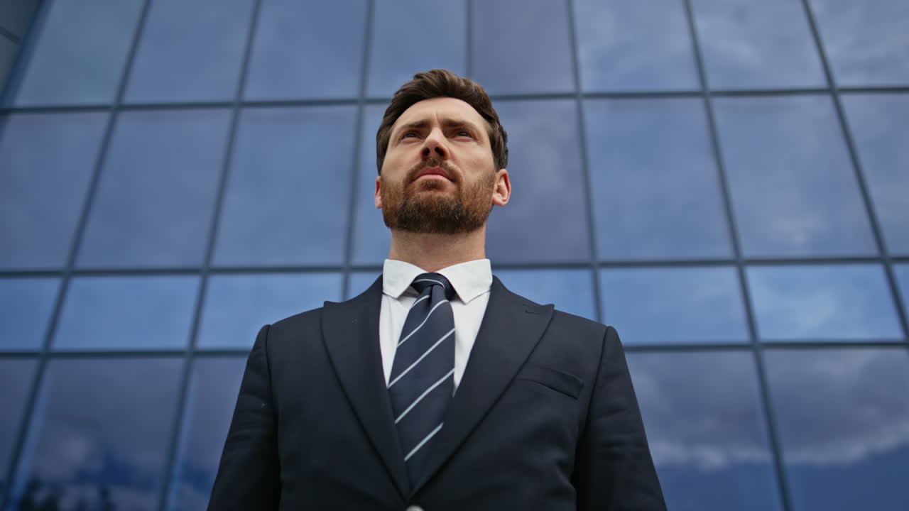 A determined businessman in front of a modern building