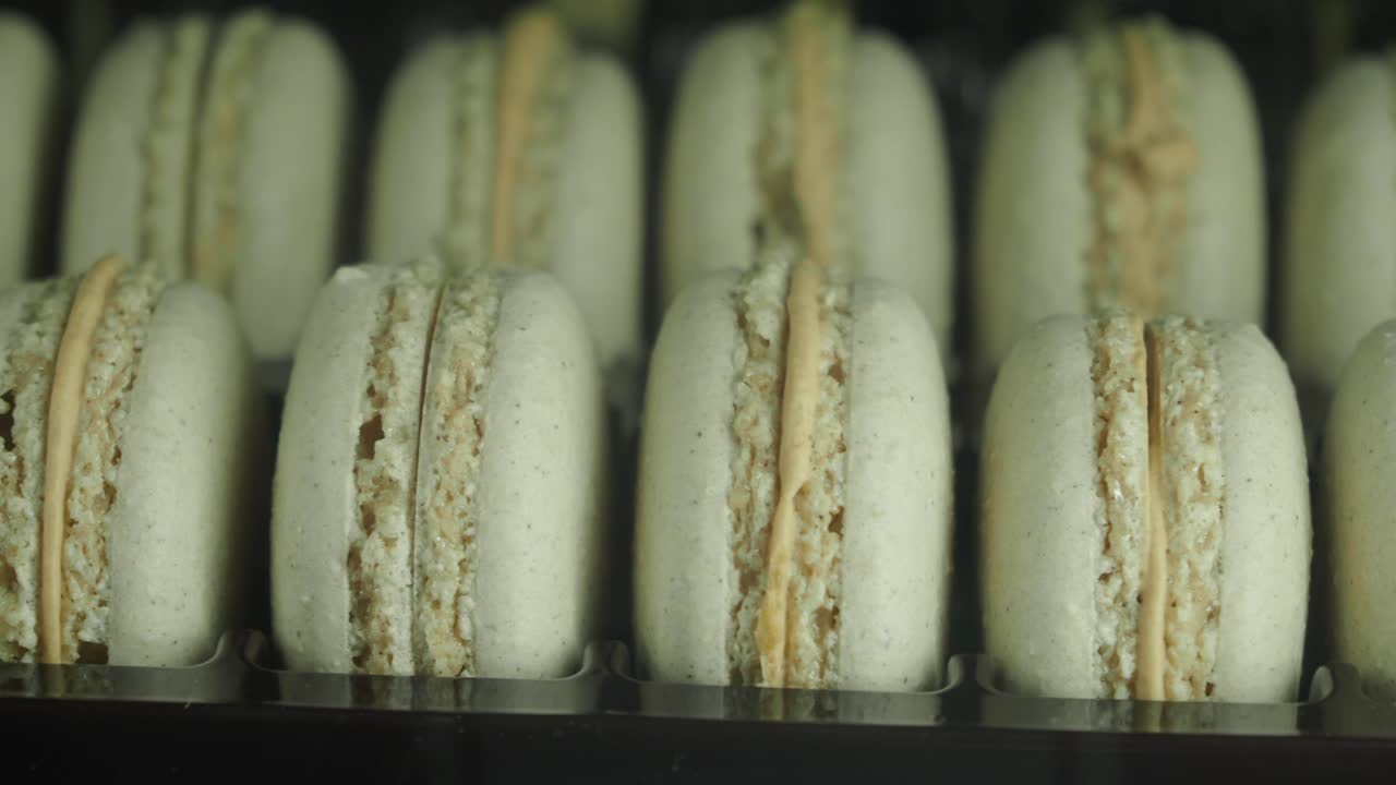 Close-Up Panning Shot of Gourmet Macarons in a Display