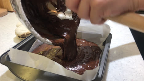 pouring-chocolate-on-block-for-making-brownies