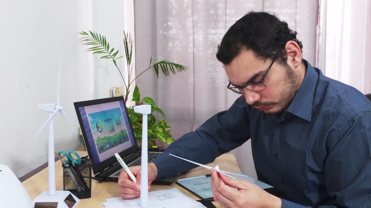 Engineer Attaching Blades to a Wind Turbine Prototype by Hand