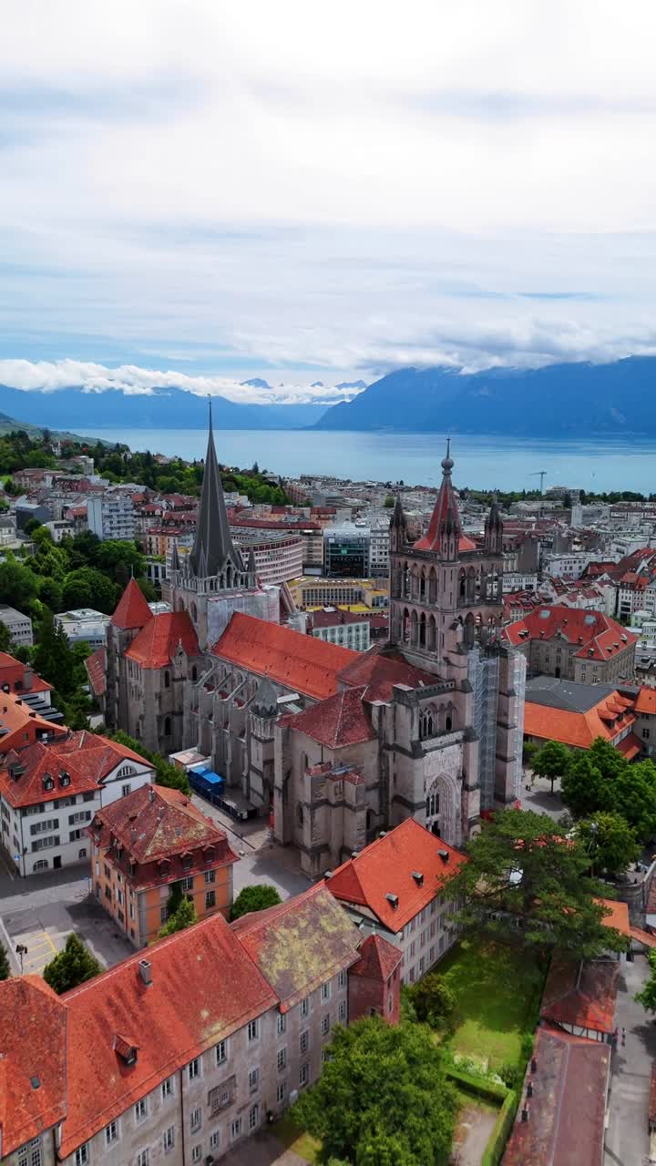 Lausanne Cathedral Gothic church in Switzerland Lake Geneva Swiss Alps, aerial drone vertical video