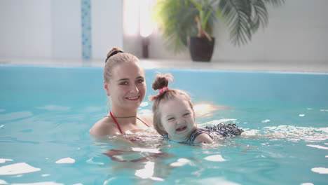 Cute-baby-boy-enjoying-with-his-mother-in-the-pool.