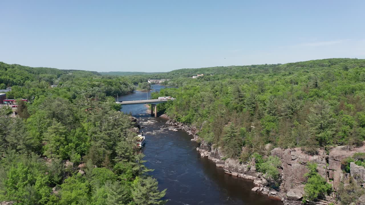 Low panning aerial shot flying over the Saint Croix River in Taylors Falls, Minnesota