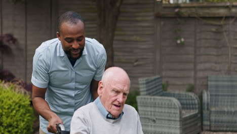 caregiver assisting senior man in wheelchair