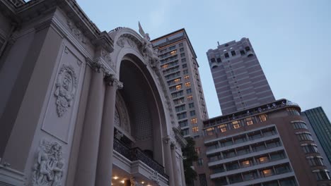 Looking-Up-On-The-Facade-Of-Ho-Chi-Minh-City-Opera-House-Against-High-rise-Hotel-Building-In-Vietnam