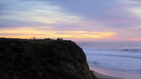 people enjoying the beautiful sunset in half moon bay, california