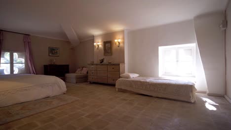 slow revealing shot of a master bedroom with a single bed within a castle in france