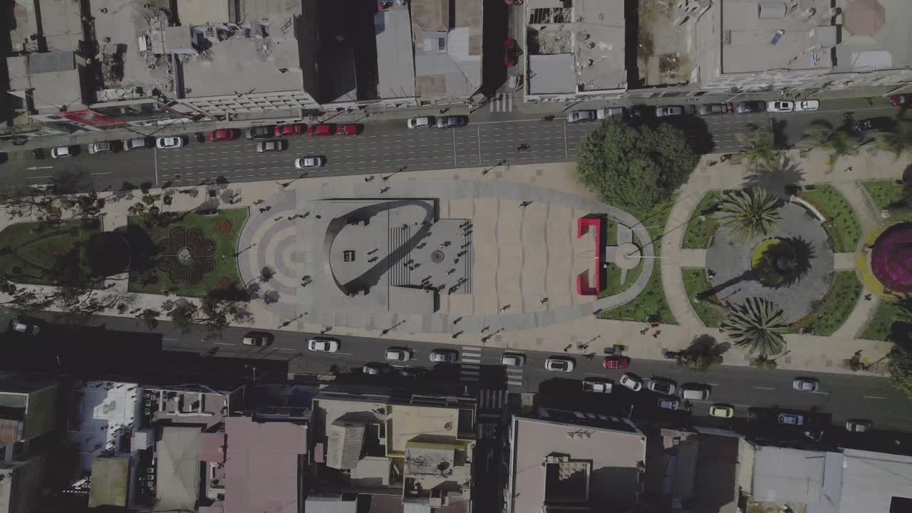 Aerial Top-Down View of a Busy City Square with Traffic and Pedestrians