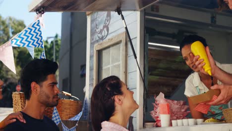 Waiter-preparing-meal-for-customer-at-the-counter