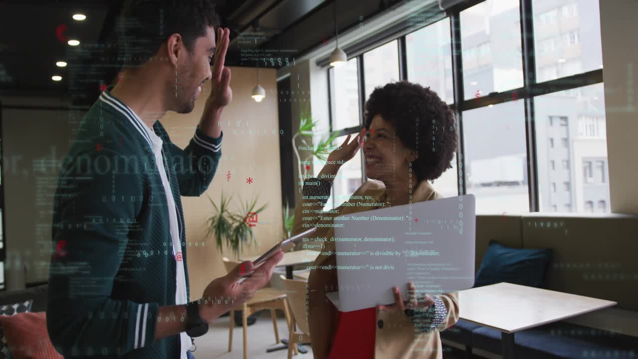 Tech coworkers using laptop tablet while woman pointing at code causing AR graphics and high-fiving
