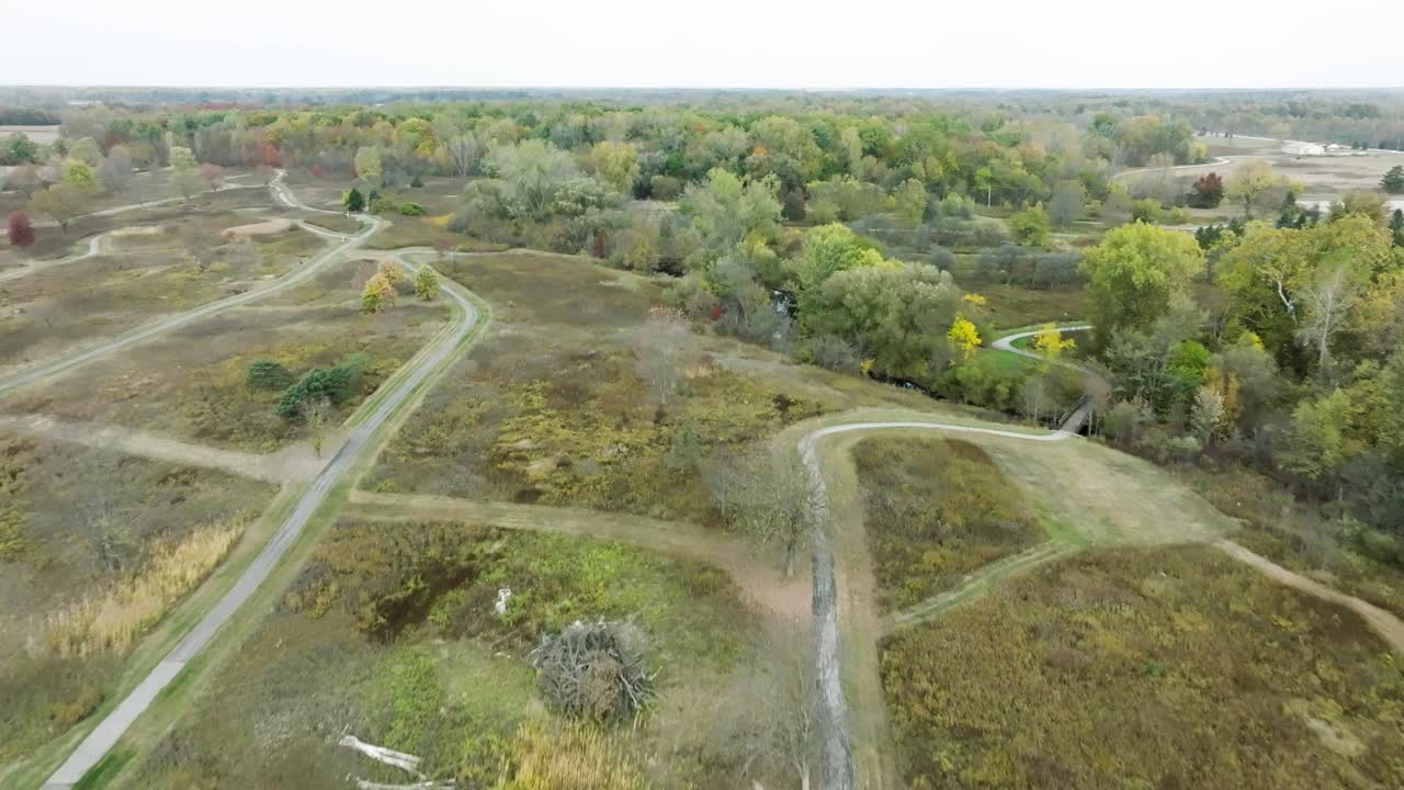 Drone flying over the North Branch Trails, a converted golf course and part of Wolcott Mills Metropark in Ray Township Michigan on a beautiful autumn day