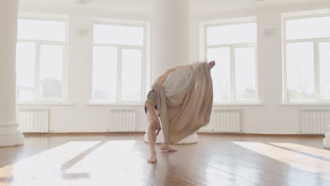 contemporary male japanese dancer training dance moves in the middle of the studio