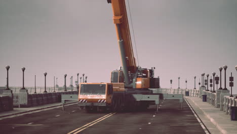 large orange crane on bridge