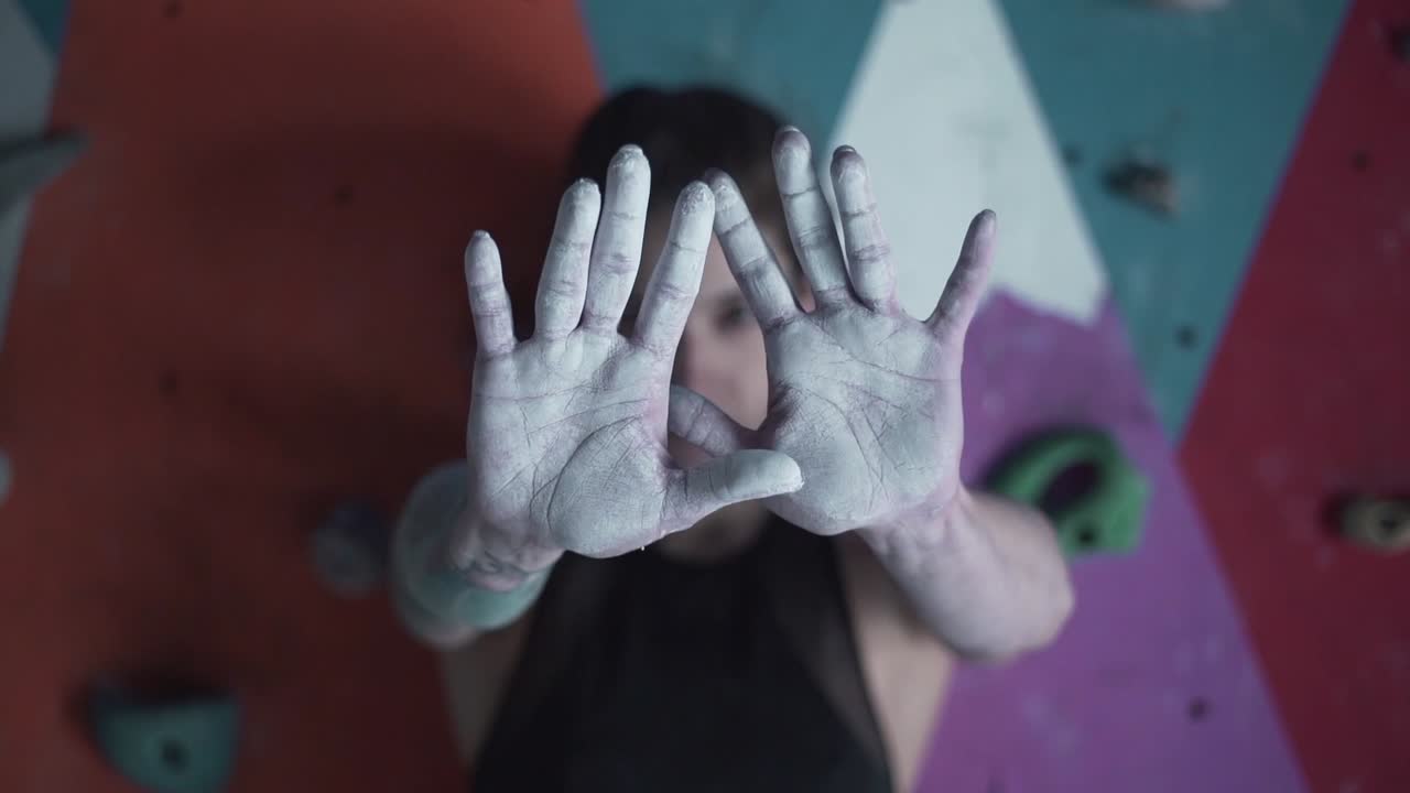 Woman Climbing Hands Covered in Chalk