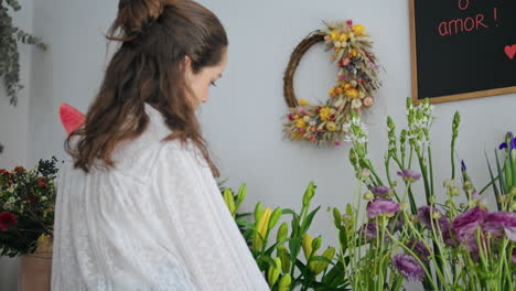 closeup beautiful floristic woman work flower bouquet in plant shop workplace.