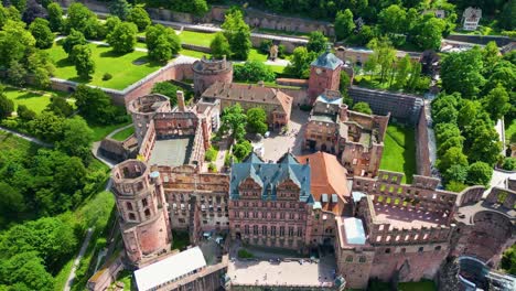4k aerial drone video of the historic castle on königstuhl hill overlooking heidelberg, germany