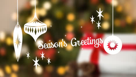 seasons greetings written in front of defocused christmas tree