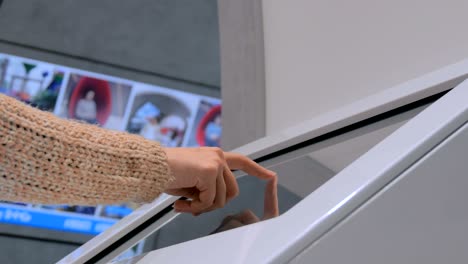 woman using interactive touchscreen display at urban exhibition