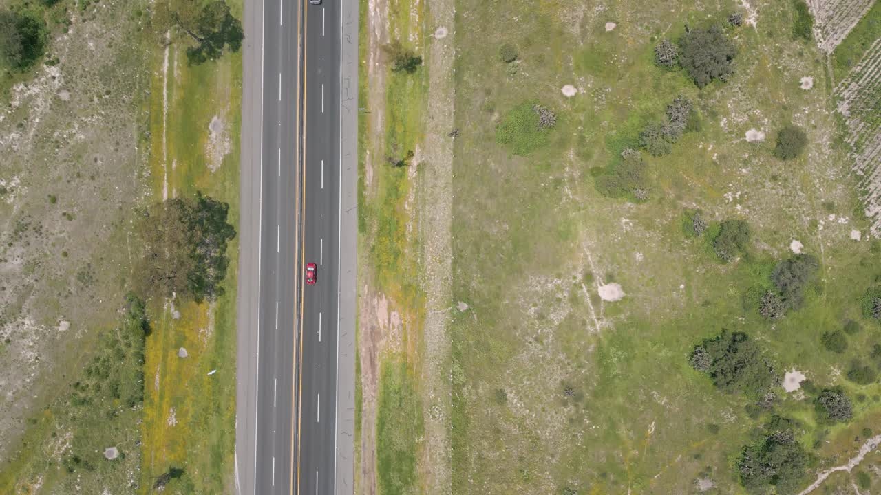 Slow Top-Down Drone Motion Over Smooth-Flowing Highway With Very Light Traffic Through Dry Rural Farmland in Mexico – Cenital Tracking Shot, Midday Sunny 4K