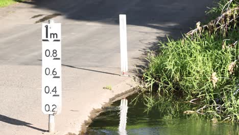 water level gauge beside a flowing stream