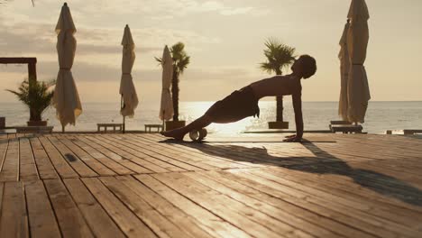 Yogi-guy-massages-his-calves-and-legs-with-a-special-cone.-Exercise-in-the-morning.-Health-and-Zen-style