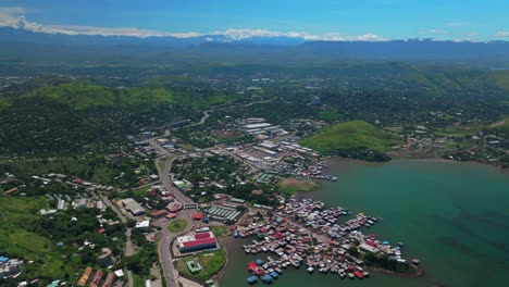 Walter-Bay-speed-boat-Port-Moresby-Papua-New-Guinea-parallax-aerial-drone-capital-city-Harbour-Marina-PNG-beautiful-sunny-blue-sky-morning-islands-Ela-Beach-Crown-Hotel-Plaza-Hilton-Coral-Sea-backward