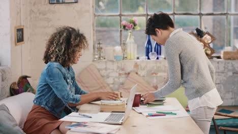 Diverse-group-of-students-studying-at-home-using-books-and-laptop-technology