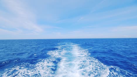 white foam trail of boat wake seen from boat, slow motion