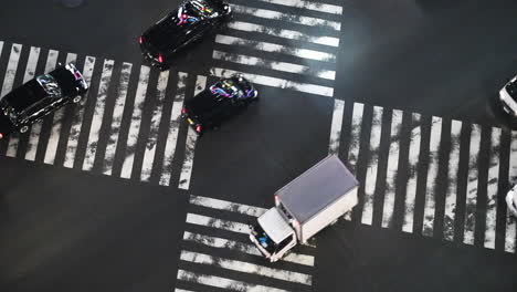 traffic driving over the famous shibuya crossing, in tokyo, japan - static view