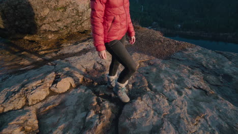 girl hiking up to rocky vantage point overlooking in washington state