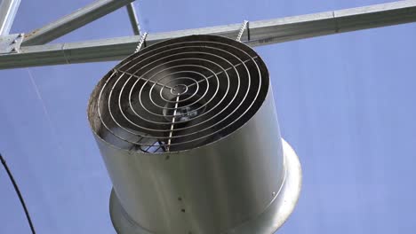 fan in greenhouse for air conditioning of cultivating fruits - close up