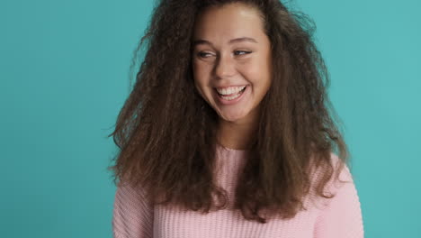 Caucasian-curly-haired-woman-making-funny-faces-in-front-of-the-camera.