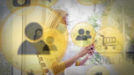 animación de iconos de compras en línea mujer caucásica con máscara facial usando un teléfono inteligente en casa
