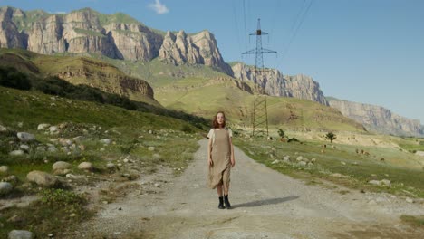 woman walking on a country road in mountains