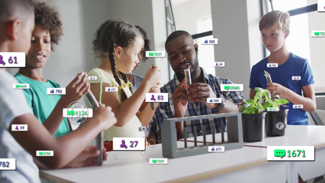 Animation of media icons over diverse schoolchildren learning with male teacher