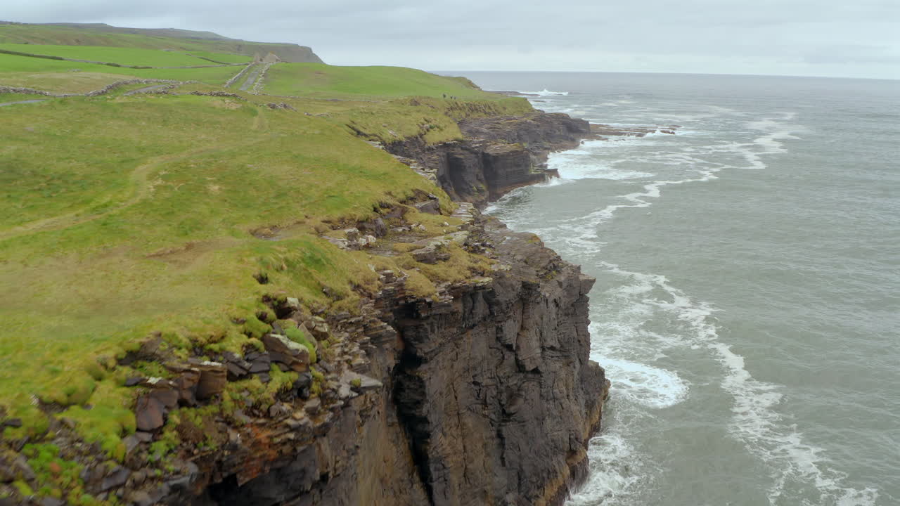 Aerial over Cliffs of Moher edge on a stormy day, Doolin side, Ireland