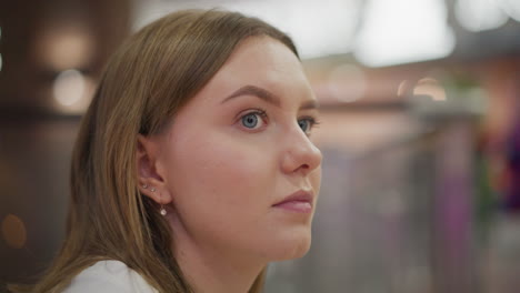 close up of lady gazing thoughtfully into distance, soft bokeh lights in background, creating a serene and introspective mood, facial expression reflects calm contemplation