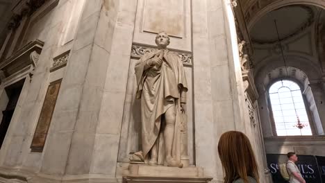 visitor admires statue inside historic cathedral