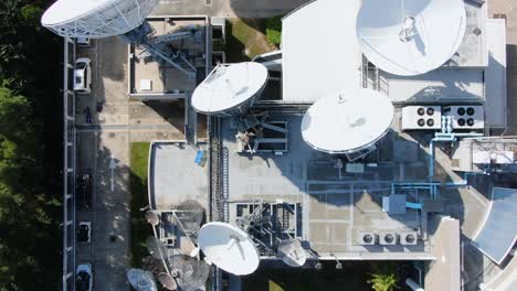 cluster of satellite broadcast dishes on hong kong, aerial view