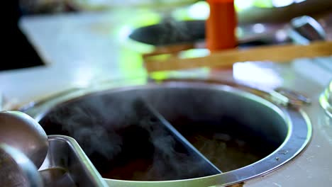 steaming noodle pot at bangkok's floating market