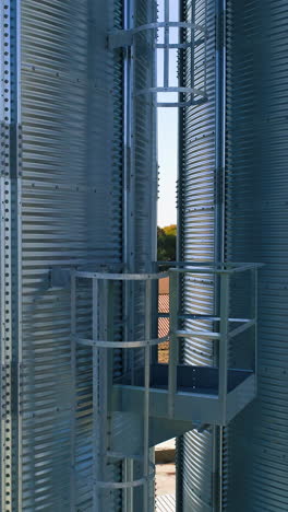 metal elevator in agriculture zone. grain warehouse or depository. vertical video