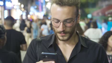 Young-man-walking-on-the-street-at-night.