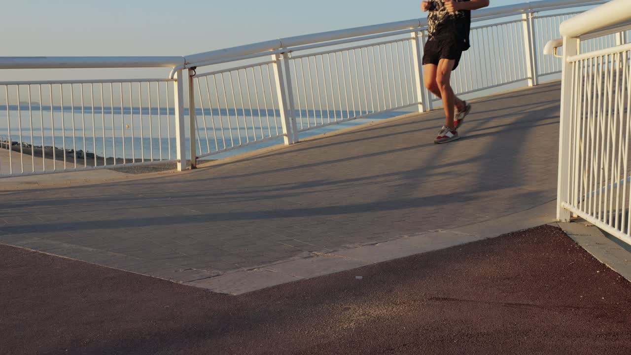 Man Running on a Coastal Bridge at Sunrise/Sunset